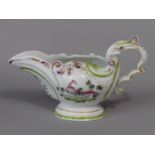A 19th century sauce boat in the 18th century Chelsea manner, with painted exotic bird and floral