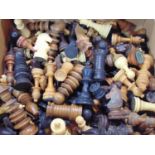 A large unsorted collection of miscellaneous traditional chess pieces, principally in box wood ebony
