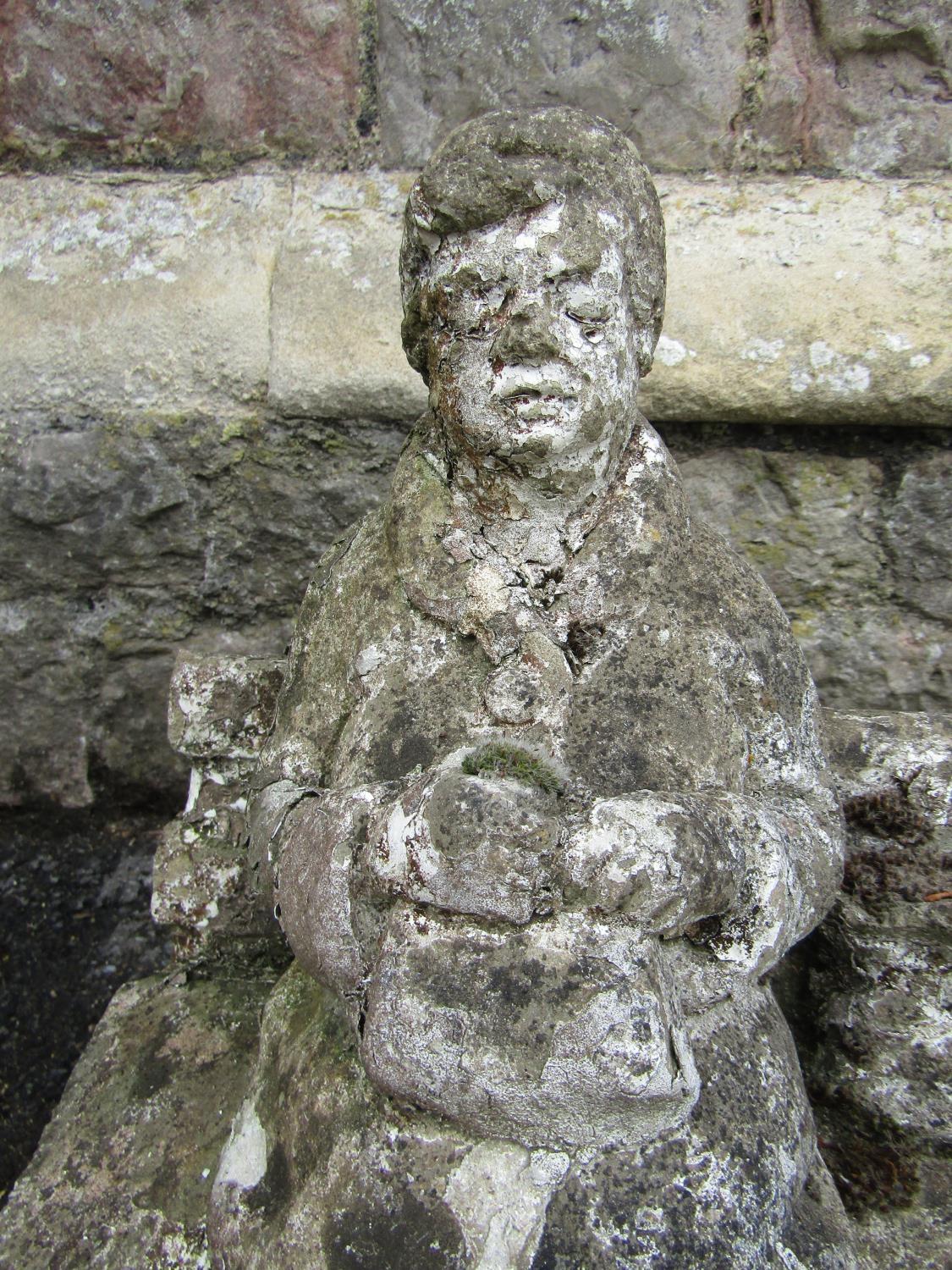 Two weathered reconstituted figures showing a character seated upon a bench and a further example of - Image 3 of 3