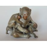 A Japanese bronze group of a mother Baboon and her three babies, in a naturalistic finish with