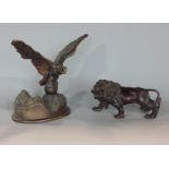 A bronze figure of an eagle with outstretched wings, together with a bronze male lion