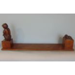 Interesting carved bookend shelf, one end mounted by a hand carved study of a seated fawn holding