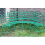 A pair of Regency style green painted light steel framed four seat sectional curved benches with
