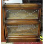 An early 20th century oak floorstanding two sectional library bookcase enclosed by rectangular