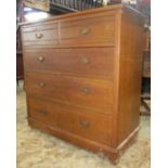 An Edwardian walnut bedroom chest of two short over three long graduated drawers with incised line