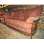 An Ercol medium elm lathe back sofa and matching armchair, with alternating, repeating floral