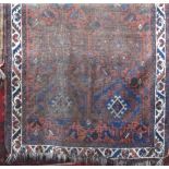 Antique well worn Persian rug with medallion decoration upon a brown ground, 150 x 110cm