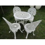 A cream painted cast aluminium garden terrace table of circular form with decorative pierced top and