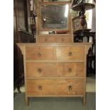 An arts and crafts ash dressing chest of two long and two short drawers, beneath two trinket drawers