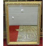 A 19th century stepped and moulded gilt frame of rectangular form with split beaded slip, foliate