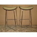 A pair of Frovi high stools with saddle shaped seats, raised on tubular polished steel supports