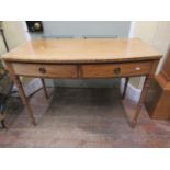 A regency mahogany bow-fronted side table fitted with two frieze drawers, brass ring handles and