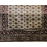 Traditional Cashmere Bokhara design carpet, with red geometric typical decoration upon an ivory