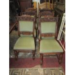 A set of six Victorian oak dining chairs with sage green dralon upholstered seats and back pads