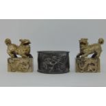 Chinese spelter napkin ring and a pair of Chinese medal seals with temple lion mounts