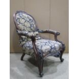 A Victorian drawing room chair, with floral patterned upholstered sprung seat with serpentine front,