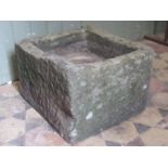 A shallow but deep based weathered natural stone trough of rectangular form, 47 cm long x 43 cm wide