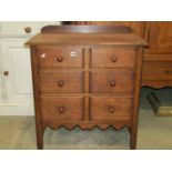 A small good quality oak bedroom chest of three long graduated drawers disguised as six small,