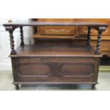 A 1920s Jacobean Revival oak monks bench, with geometric mouldings, sliding top and box base with