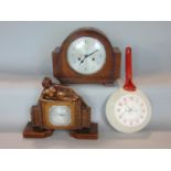 A collection of novelty clocks to include an art deco plaster clock, mounted by a scantily clad