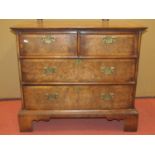 A mid-18th century style walnut and figured walnut chest of two long and two short drawers, the