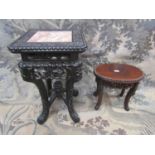 A good Chinese hardwood stand of oval form raised on scrolled toes with carved and pierced