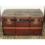 A large vintage timber lathe and steel banded domed top trunk with studded initials to lid GL,