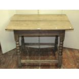 An 18th century oak side/occasional table, the rectangular overhanging two plank top raised on