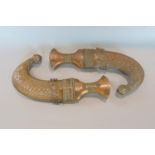 Two interesting eastern copper Jambaya daggers, with decorative sheaths (2)