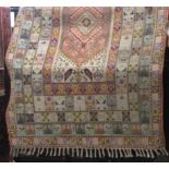 Eastern carpet with thick tasselled decoration, centrally decorated with a pink medallion with