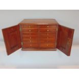 A good late Victorian mahogany table top specimen cabinet, the moulded top over twin doors,