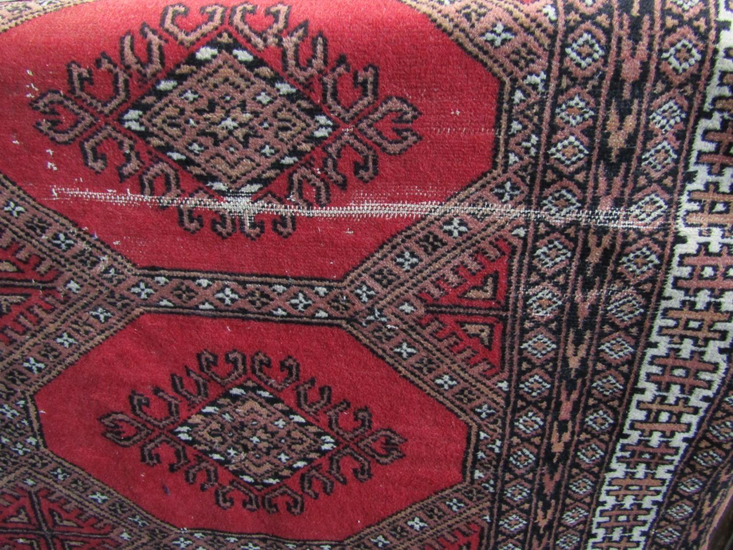 Bokhara type rug with fawn medallions upon a red ground, 200 x 130cm - Image 3 of 4