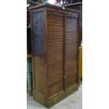 An early 20th century oak framed double door, floorstanding tambour filing cabinet with rise and
