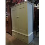 A painted pine side cupboard/dwarf robe partially enclosed by a pair of rectangular panelled doors