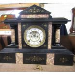 A good quality twin train black slate mantel clock, the architectural case with turned pillars,