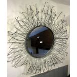 A contemporary sunburst light metal framed wall mirror of circular form with lattice strapwork