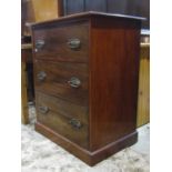 A small mahogany bedroom chest of three long drawers with oval brass plate handles and moulded