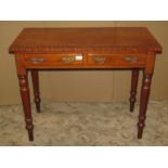 A Victorian mahogany side table with crossbanded top over two frieze drawers raised on turned
