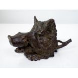 A good heavy bronze inkwell in the form of a boar's head, with hinged cover, to the rear a pen rest,