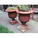 A pair of Doulton Lambeth garden urns with flared rims and raised repeating acanthus leaves and