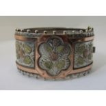 Aesthetic movement hinged silver bangle with applied tri-colour rose decoration, engraved detail and