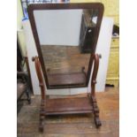 A Victorian mahogany cheval glass of usual form on shaped supports and platform base