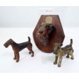 Two cold painted bronze models of fox terriers and a further ceramic fox terrier mask mounted on