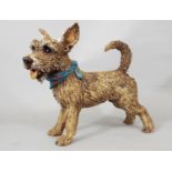 A studio pottery figure of a terrier with spotted neckerchief by Joanna Cooke, 25cm high
