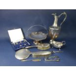 A collection of silver comprising two sugar tongs, butter knife, three piece dressing set comprising