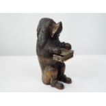 A carved figure of a standing Poodle holding a brass cased vesta, 27cm max