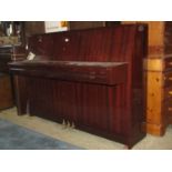 A Yamaha upright iron framed and over strung piano model M5J with polished mahogany case 88 keys and