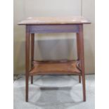 An Edwardian satinwood two tier occasional table of rectangular form with inlaid crossbanded