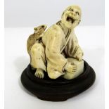 Meiji Period - Ivory Okimono of an old man crouching, surprised by a large rat jumping upon his