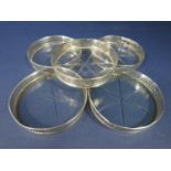 Five silver and star-cut glass coasters with raised gallery rims (5)